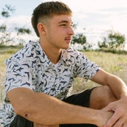 Shark Paradise Adult Shirt features a vibrant tropical shark pattern on a classic Hawaiian button-up style. | Tropicool Clothing