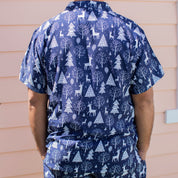 Navy Christmas adult shirt featuring white reindeer and tree patterns, festive tropical holiday style. | Tropicool Clothing