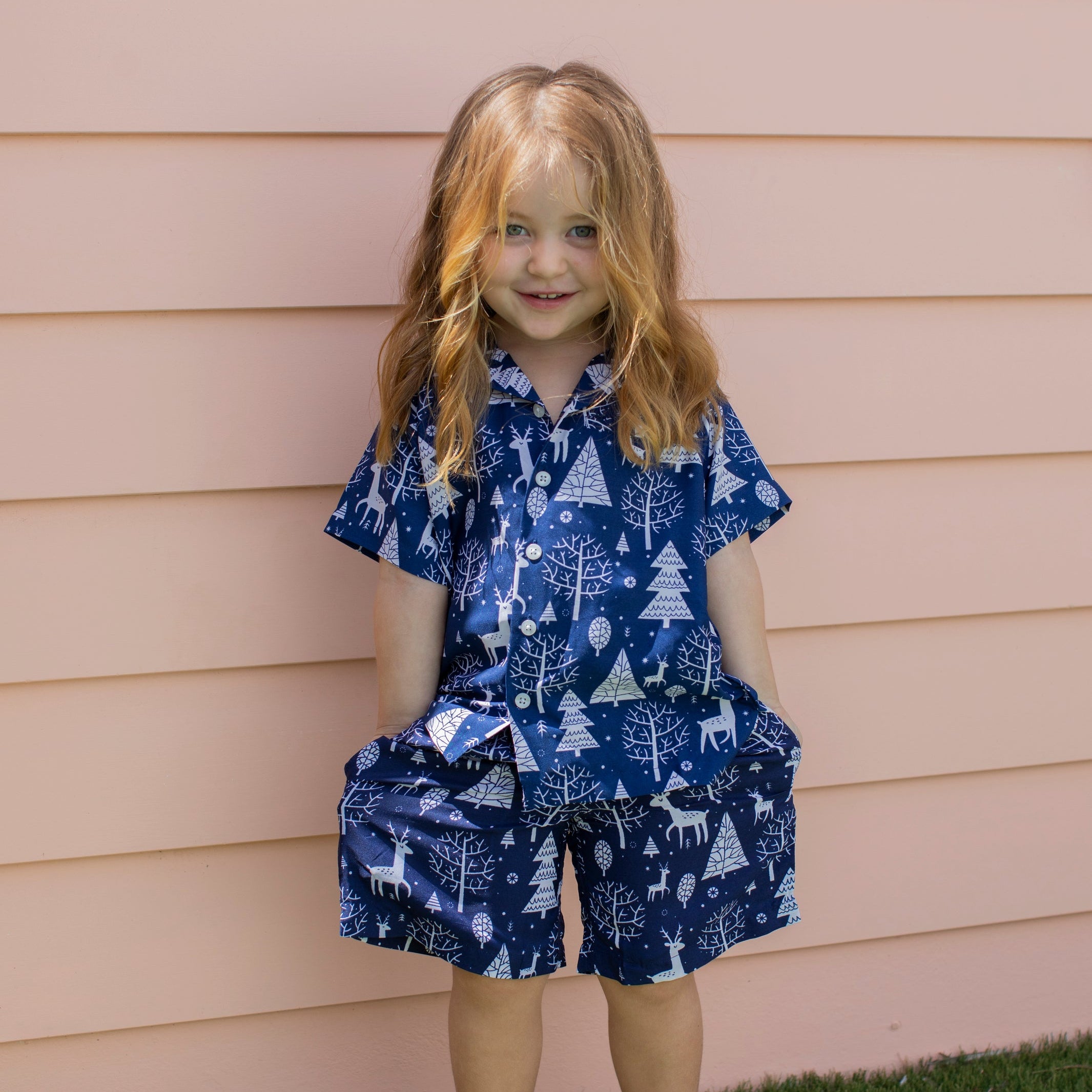 Navy Christmas kids shirt with white reindeer and tree patterns, festive blue outfit, holiday tropical style. | Tropicool Clothing