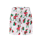 White kids swim trunks with green Gremlin in Santa outfit print and white drawstring waist. Festive tropical shorts. | Tropicool Clothing
