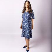 Woman wearing Tropicool Alice Reindeer Navy Christmas dress, front view, showcasing relaxed fit and festive print