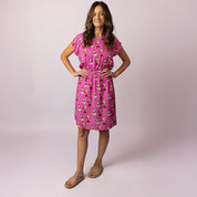 Woman wearing the Alice Santa Polka Pink Adult Dress by Tropicool – breathable summer Christmas dress with fun Santa print, perfect for festive family matching outfits.