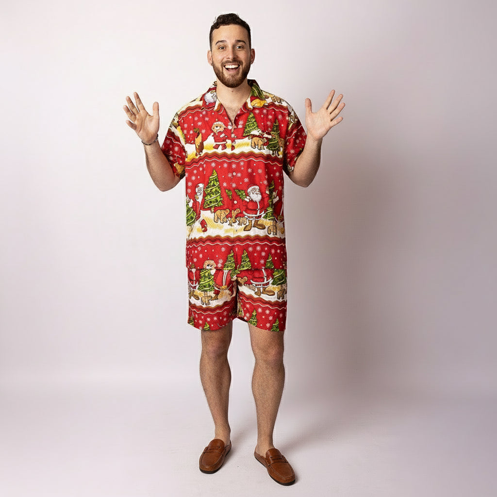 A man wearing the Tropicool Happy Santa Red adult Christmas shirt, smiling in a playful pose with a Santa hat. Fun Aussie festive outfit perfect for parties, summer events, and matching family looks.