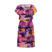 Sunset Purple Isla Dress with vibrant tropical sunset and palm tree print; festive vacation style. | Tropicool Clothing