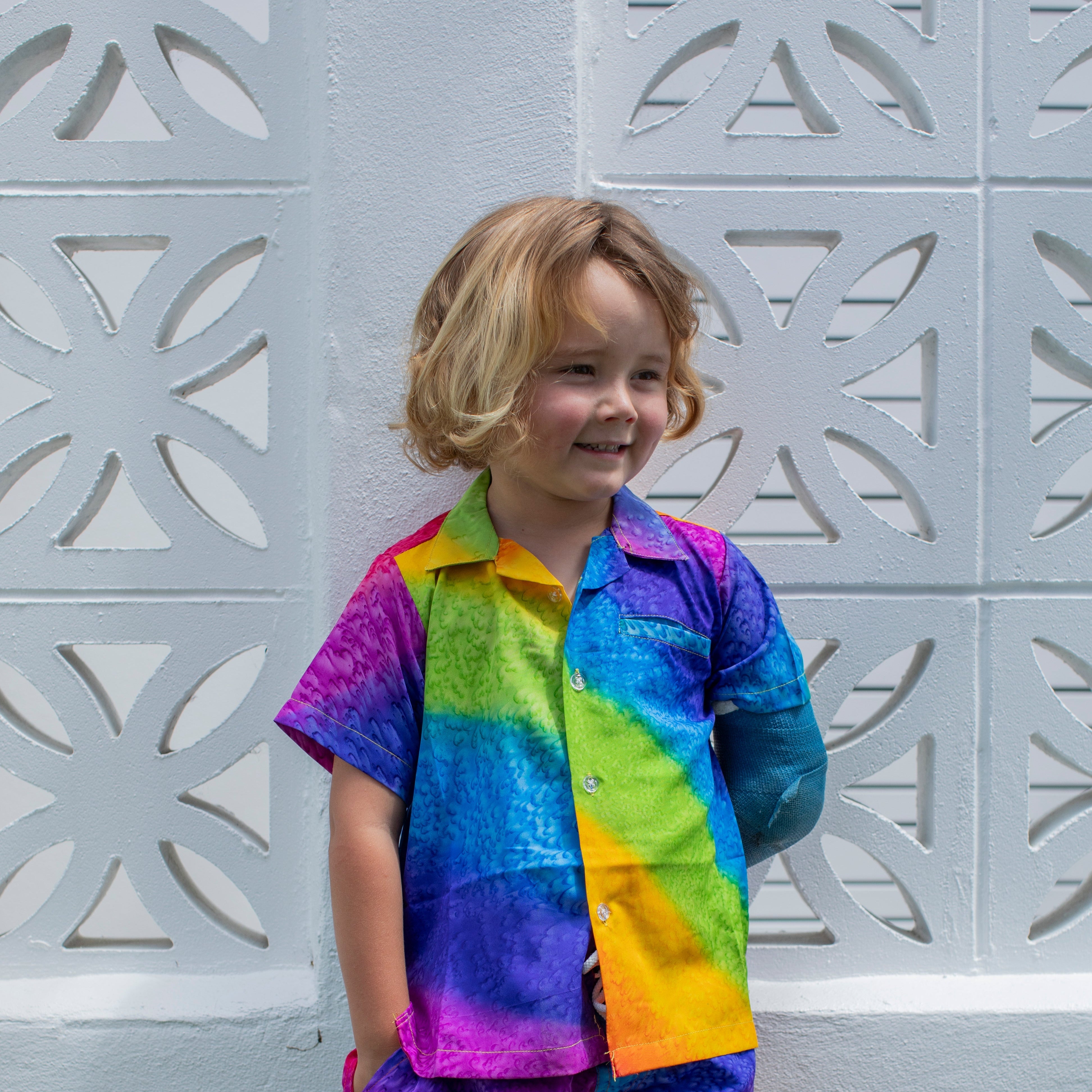 Rainbow Kids Shirt with vibrant multicolored stripes, tropical-inspired, festive short-sleeve style. | Tropicool Clothing