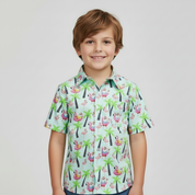 Kid wearing Santa Sip & Blue shirt featuring Santa on flamingo floats with palm trees on a light blue tropical background.