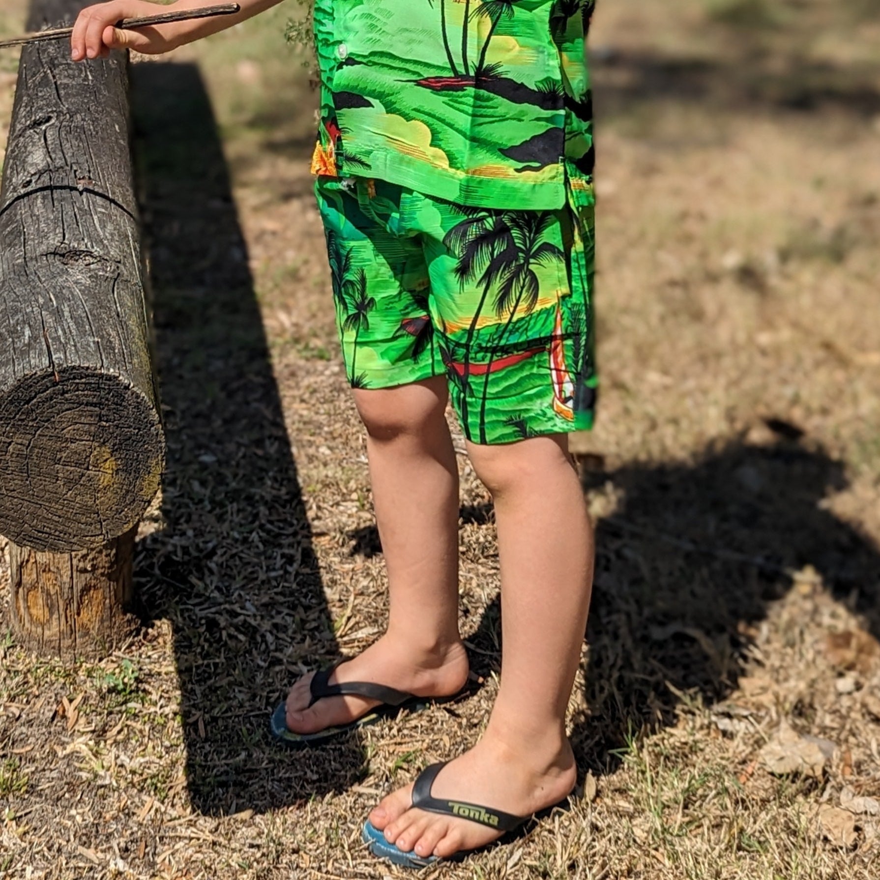Sunset green kids shorts with a tropical vibe; classic fit, vibrant hue, perfect for festive summer wear. | Tropicool Clothing